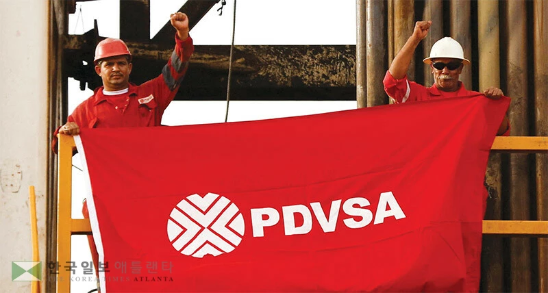  베네수엘라 국영석유기업 ‘PDVSA’ 직원들이 대통령 체포에 반발, 회사 깃발을 들고 항의하고 있다. [로이터]
