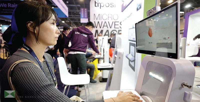  CES 2026 참석자가 지난 7일 우노빈스 부스에 설치된 우노 브레인 바디 건강 검진기에 앉아서 체험하고 있다. [로이터]