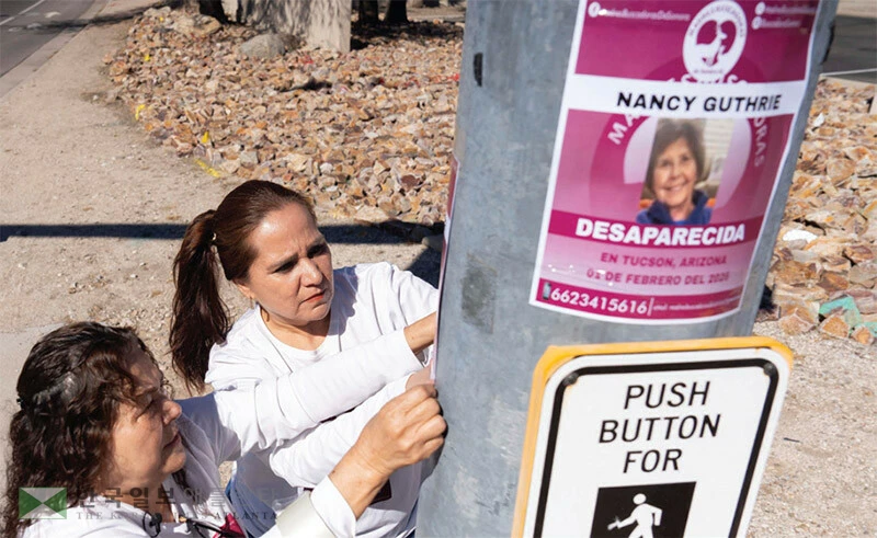  애리조나주 투산에서 주민들이 실종된 낸시 거스리를 찾는 전단지를 붙이고 있다. [로이터]