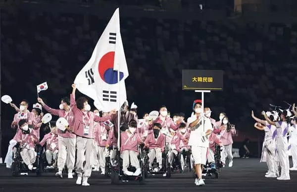 24일 오후 일본 도쿄 신주쿠의 국립경기장(올림픽 스타디움)에서 열린 2020 도쿄 패럴림픽 개회식에서 대한민국 선수단이 입장하고 있다. 기수는 최예진(보치아)과 그의 경기 파트너인 어머니 문우영씨가 맡고 있다.[로이터]